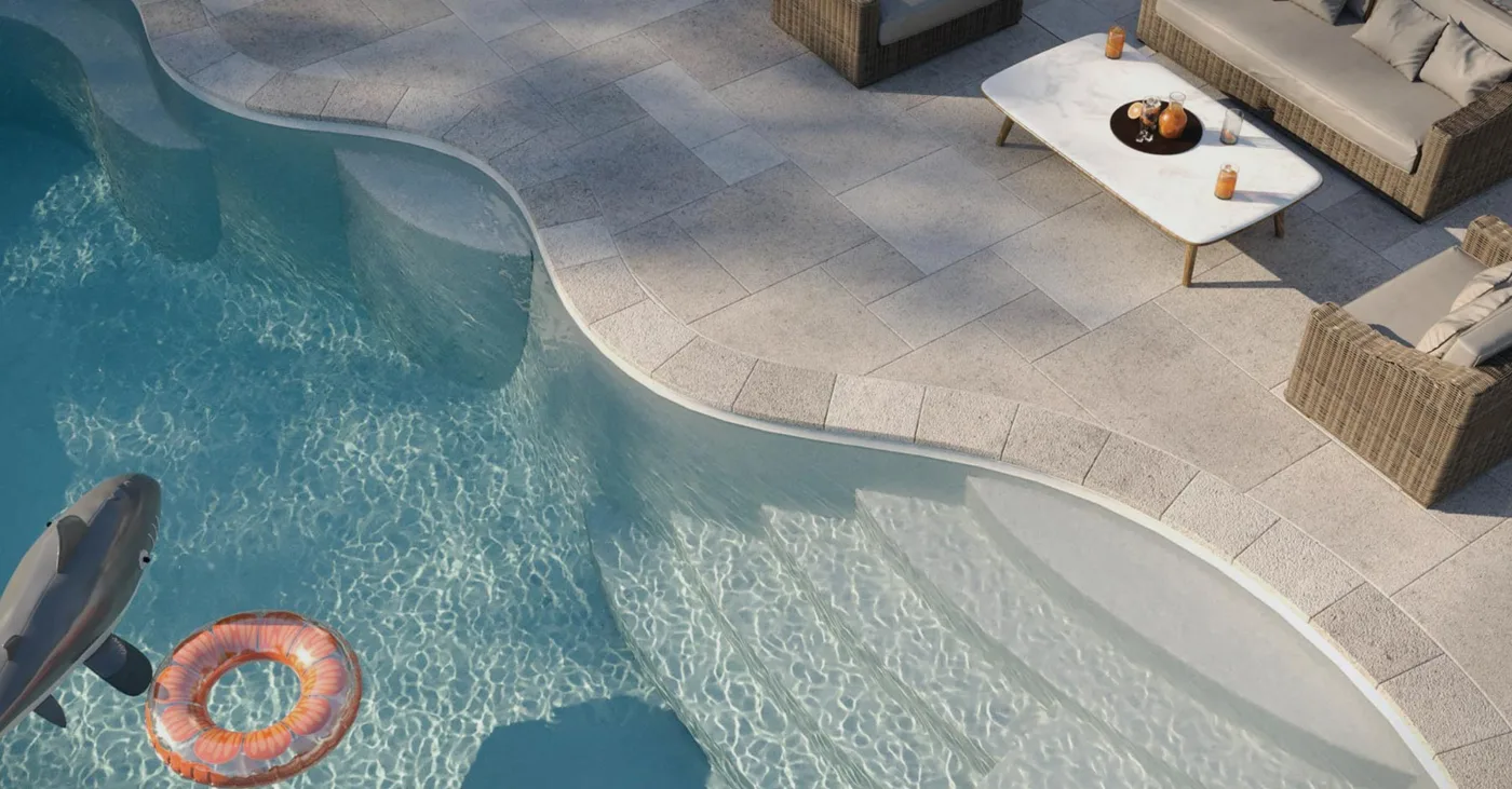 A backyard pool with floats on crystal clear water